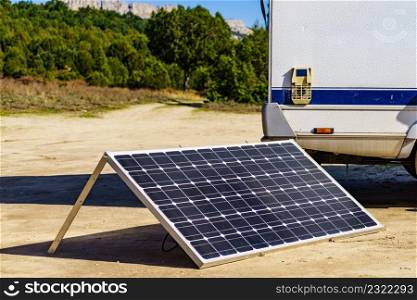Portable solar photovoltaic panel, charging battery at camper car rv.. Solar photovoltaic panel at camper caravan