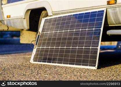 Portable solar photovoltaic panel, charging battery at camper car rv. Solar photovoltaic panel at caravan