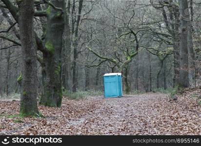 portable toilet in the middle of winter forest in the netherlands
