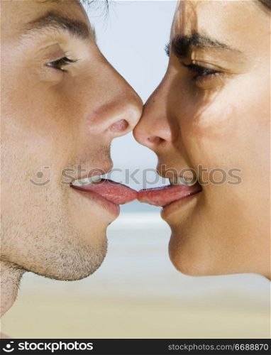Portait of a young couple giving a tonge kiss