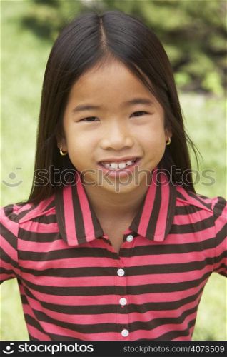 Portait Of Smiling Young Girl Outdoors