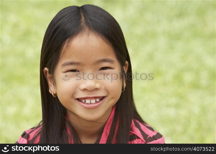 Portait Of Smiling Young Girl Outdoors