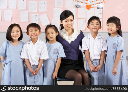 Portait Of Teacher And Students In Chinese School Classroom