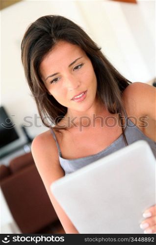 Portait of woman websurfing on electronic tablet