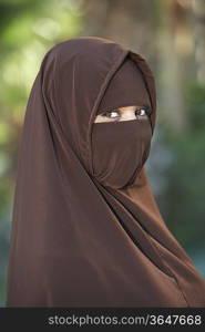 Portarit of young woman in brown niqab