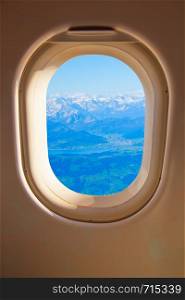 Porthole - Swiss Alps through airplane side window