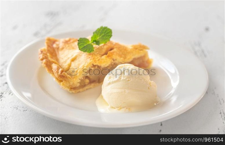 Portion of apple pie with ball of ice-cream