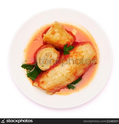 Portion of cabbage rolls stuffed with ground beef and rice with sour cream on a plate. High quality photo. Portion of cabbage rolls stuffed with ground beef and rice with sour cream on a plate
