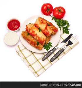 Portion of cabbage rolls stuffed with ground beef and rice with sour cream on a plate. High quality photo. Portion of cabbage rolls stuffed with ground beef and rice with sour cream on a plate
