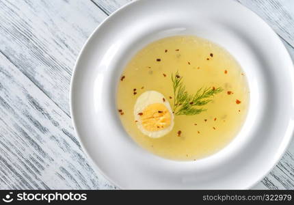 Portion of chicken stock on the wooden table