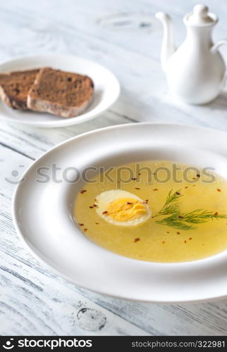 Portion of chicken stock on the wooden table