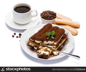 portion of Classic tiramisu dessert, savoiardi cookies and cup of fresh espresso coffee isolated on white background with clipping path embedded. portion of Classic tiramisu dessert, savoiardi cookies and cup of fresh espresso coffee isolated on white background with clipping path