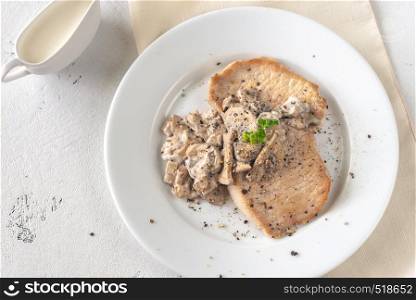 Portion of creamy garlic mushroom pork flat lay