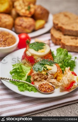 Portion of delicious chicken aspic on a plate isolated on concrete table. High quality photo. Portion of delicious chicken aspic on a plate isolated on concrete table