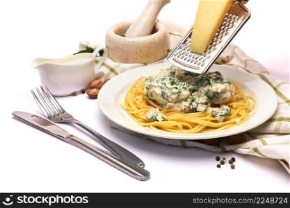Portion of delicious meatballs with spinach in a creamy sauce and pasta. High quality photo. Portion of delicious meatballs with spinach in a creamy sauce and pasta