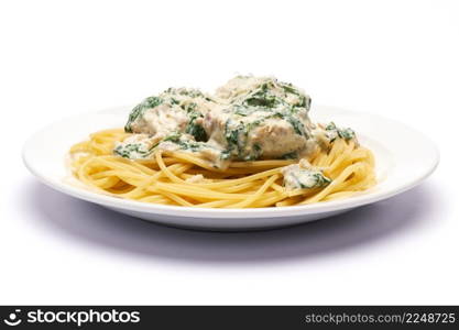 Portion of delicious meatballs with spinach in a creamy sauce and pasta. High quality photo. Portion of delicious meatballs with spinach in a creamy sauce and pasta