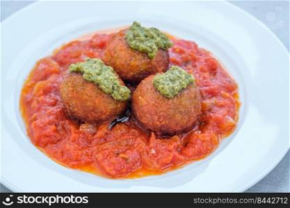 Portion of fish balls with tomato sauce