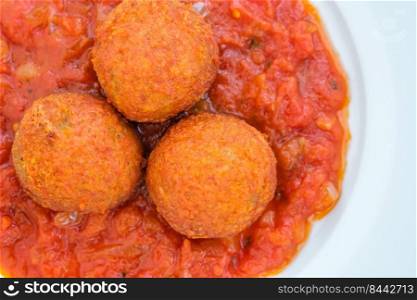 Portion of fish balls with tomato sauce