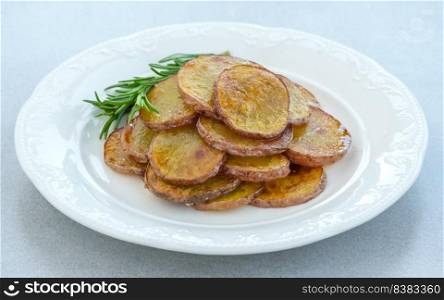 Portion of fried sliced potatoes on the plate