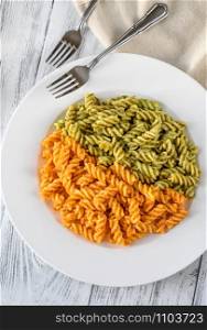 Portion of fusilli pasta with traditional and tomato pesto
