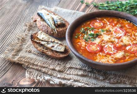 Portion of green lentil tomato soup with toasts