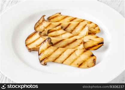 Portion of grilled eryngii mushrooms on the plate
