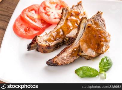 Portion of grilled pork ribs in barbecue sauce