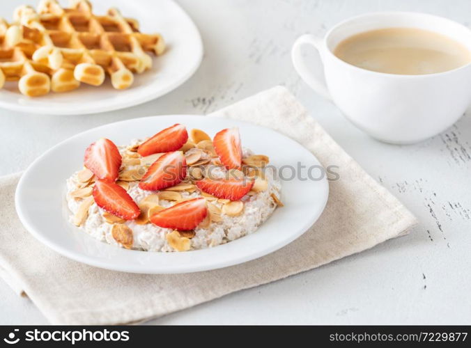 Portion of homemade Bircher muesli with cup of coffee