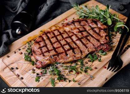 portion of juicy grilled beef steak with peppercorns