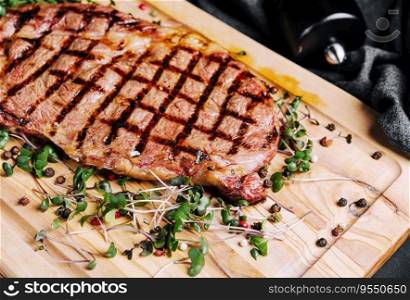 portion of juicy grilled beef steak with peppercorns