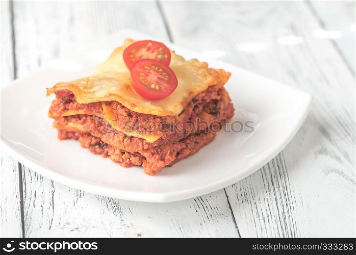Portion of lasagne on the white plate