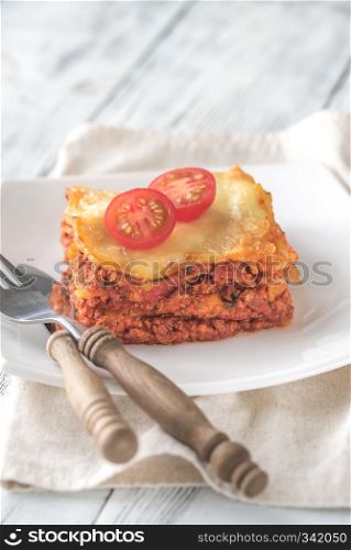 Portion of lasagne on the white plate