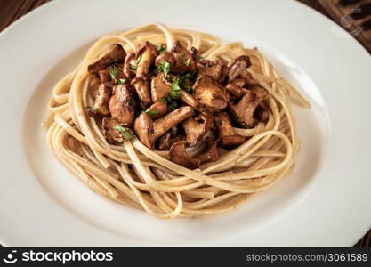 Portion of linguine pasta with fried chanterelles