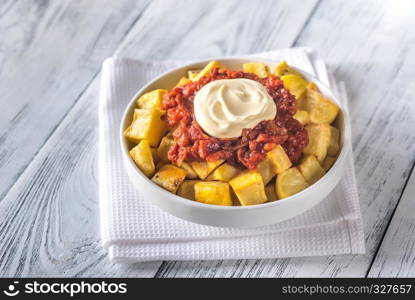 Portion of patatas bravas with sauces