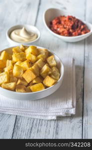 Portion of patatas bravas with sauces