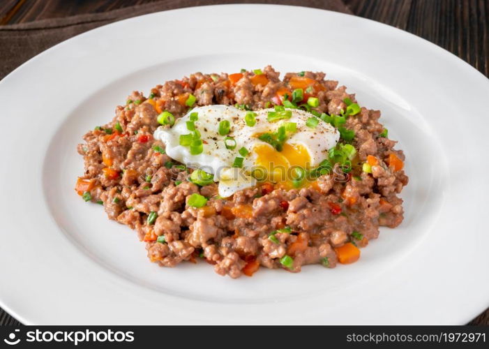 Portion of poached eggs with mince meat