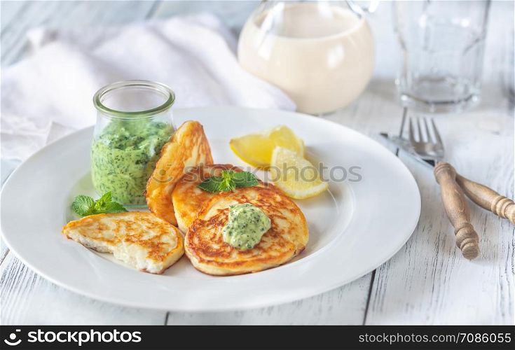 Portion of ricotta fritters with mint sauce