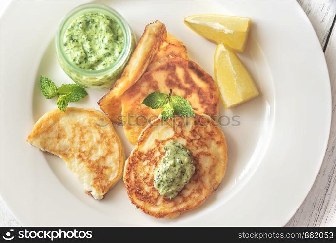 Portion of ricotta fritters with mint sauce: top view