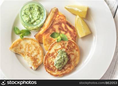 Portion of ricotta fritters with mint sauce: top view