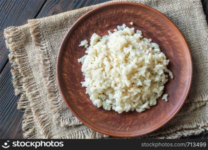 Portion of risotto on the wooden table