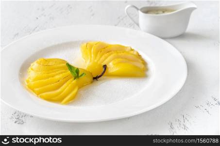 Portion of Saffron Poached Pears on white plate