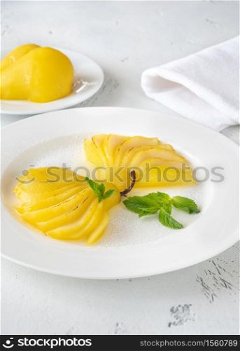 Portion of Saffron Poached Pears on white plate