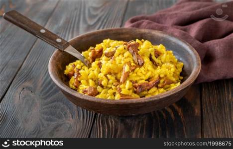 Portion of saffron risotto with fried chanterelles