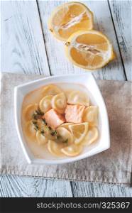 Portion of seafood ravioli soup