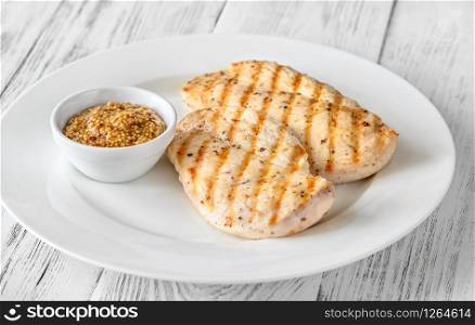 Portion of seasoned grilled chicken with Dijon mustard