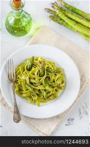 Portion of spinach fettuccine with fried asparagus