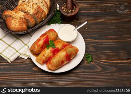 Portion of stuffed cabbage rolls on wooden table. High quality photo. Portion of stuffed cabbage rolls on wooden table