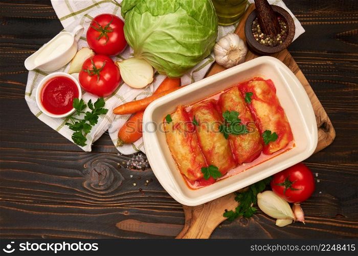 Portion of stuffed cabbage rolls on wooden table. High quality photo. Portion of stuffed cabbage rolls on wooden table