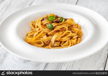 Portion of tagliatelle pasta puttanesca in the plate