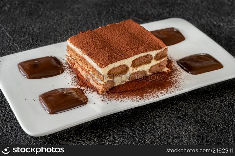 Portion of tiramisu - Italian dessert garniched with chocolate